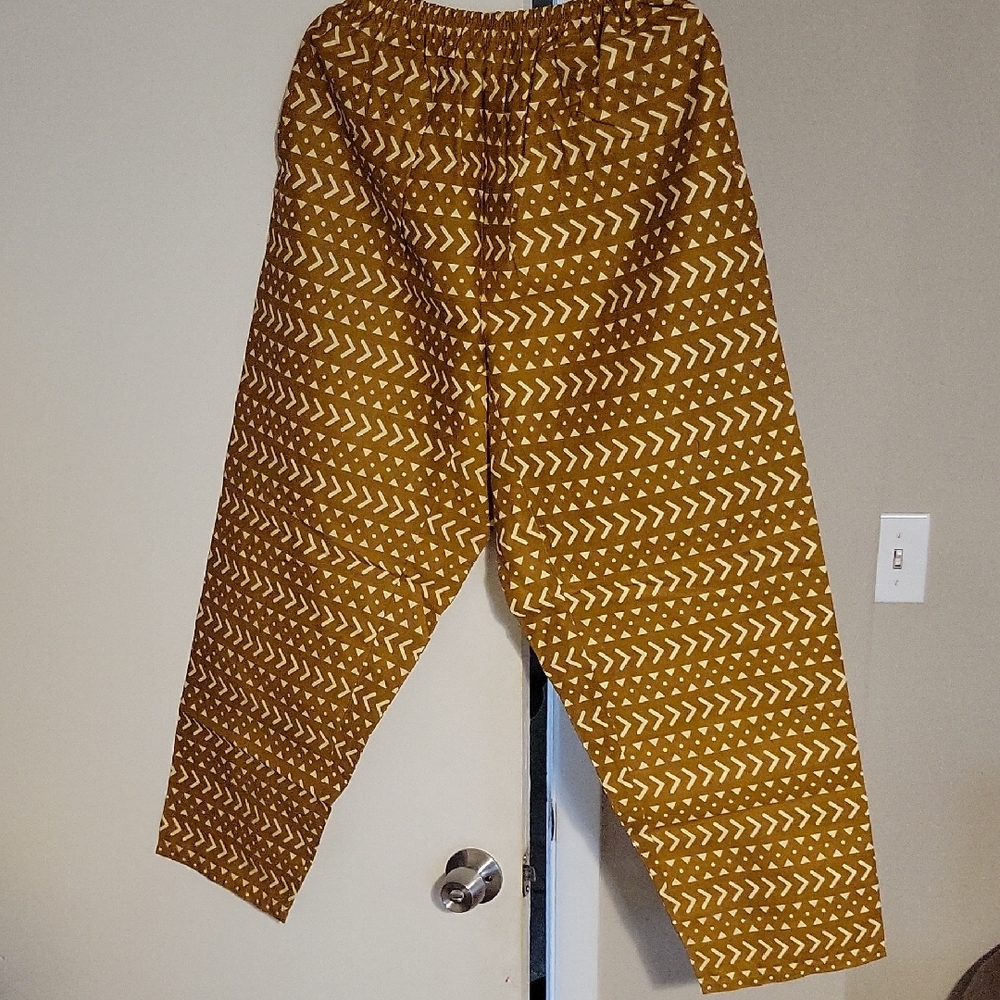 Brown Patterned Pants. With A Cap